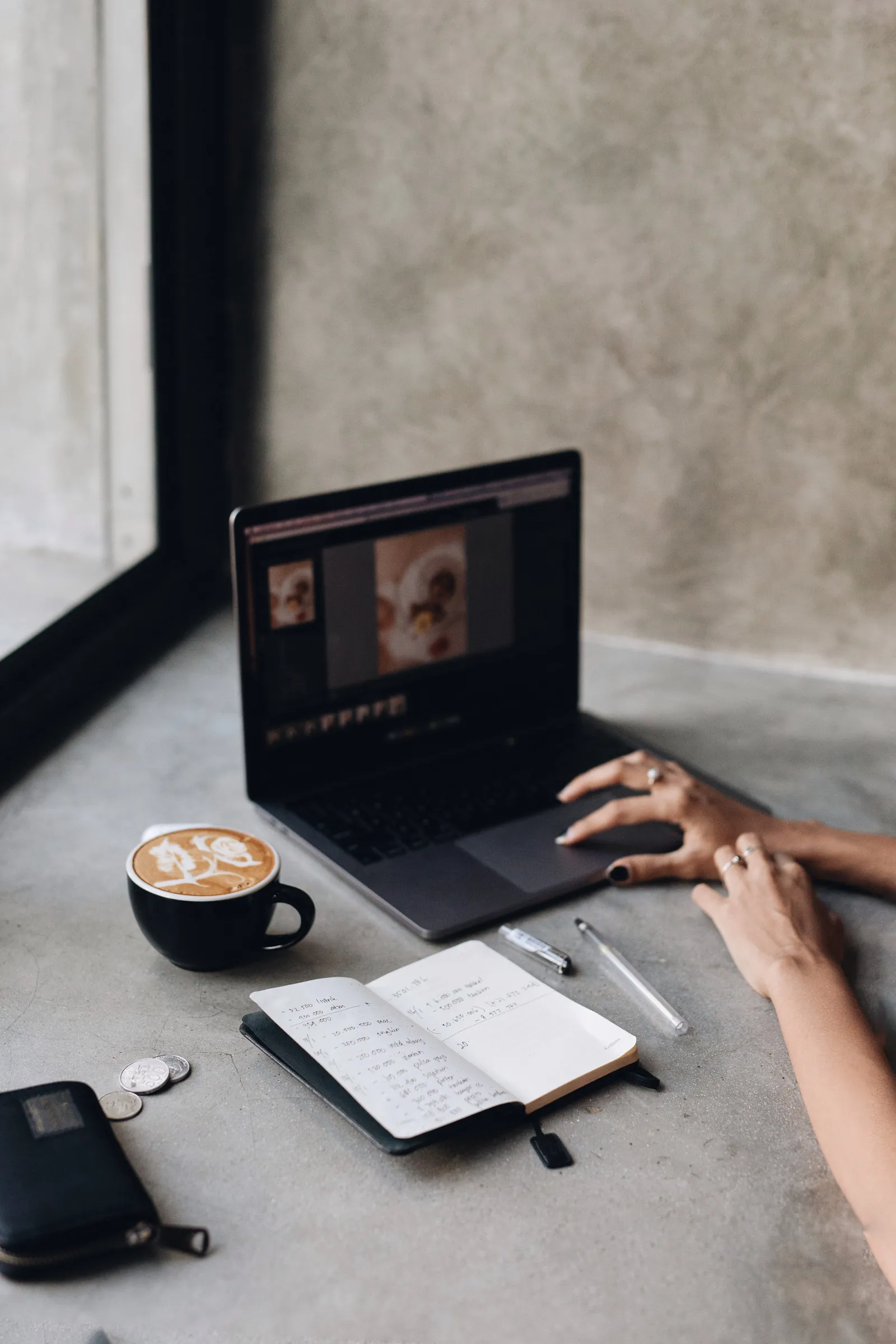 Coffee, a notebook of figures and a laptop — planning a small business